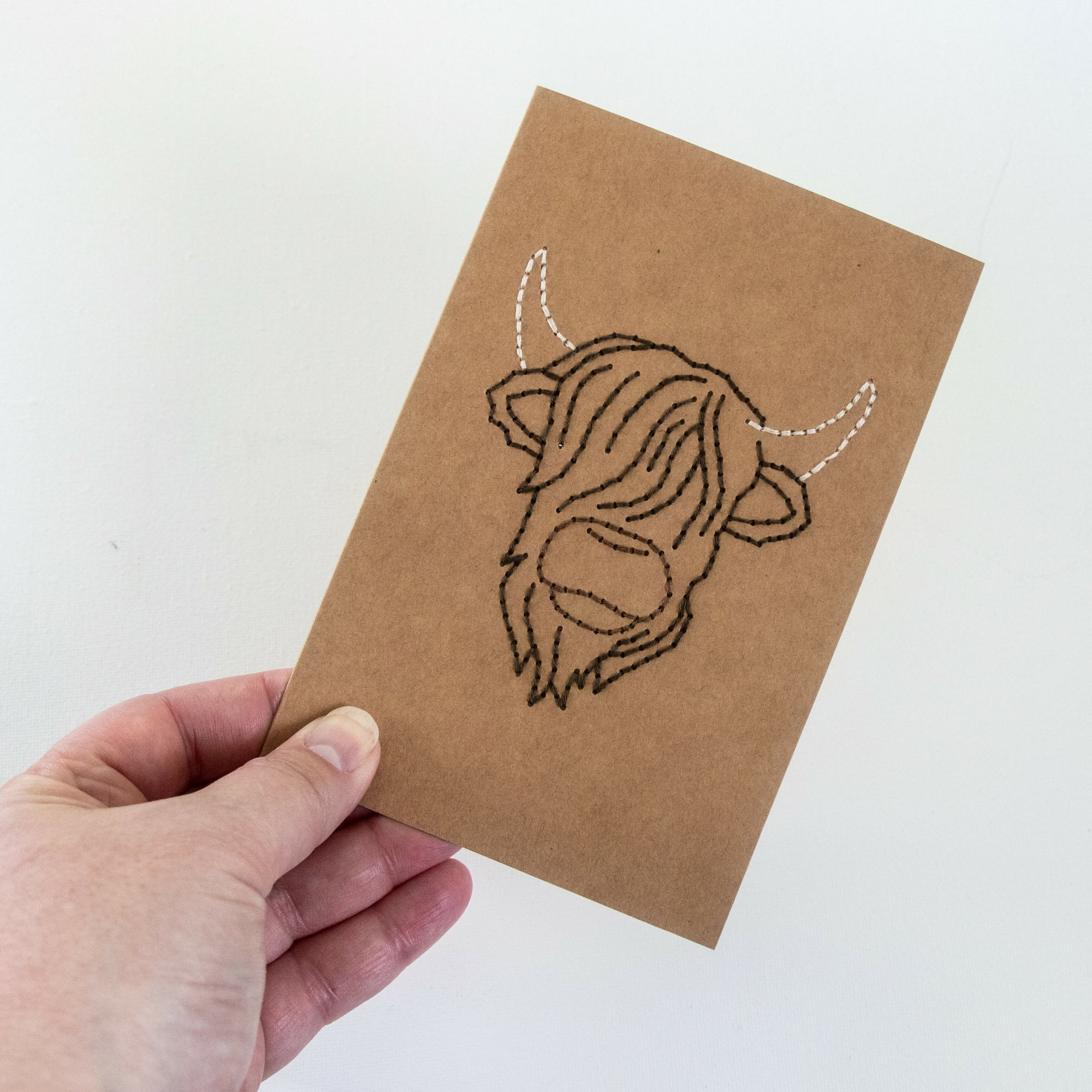 Highland Cow Greeting Card in hand