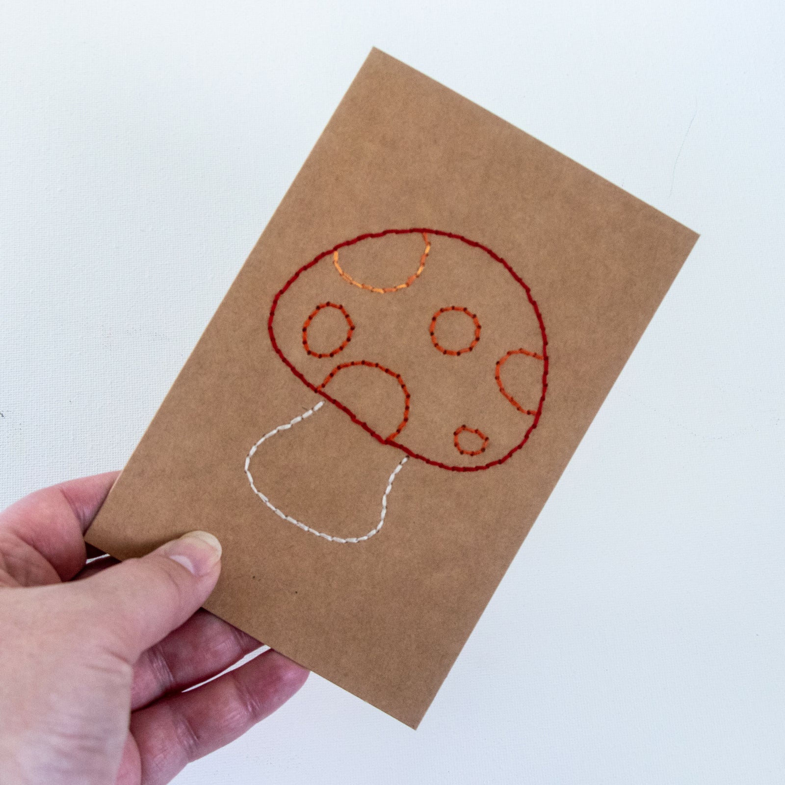 Toadstool Greeting Card in hand