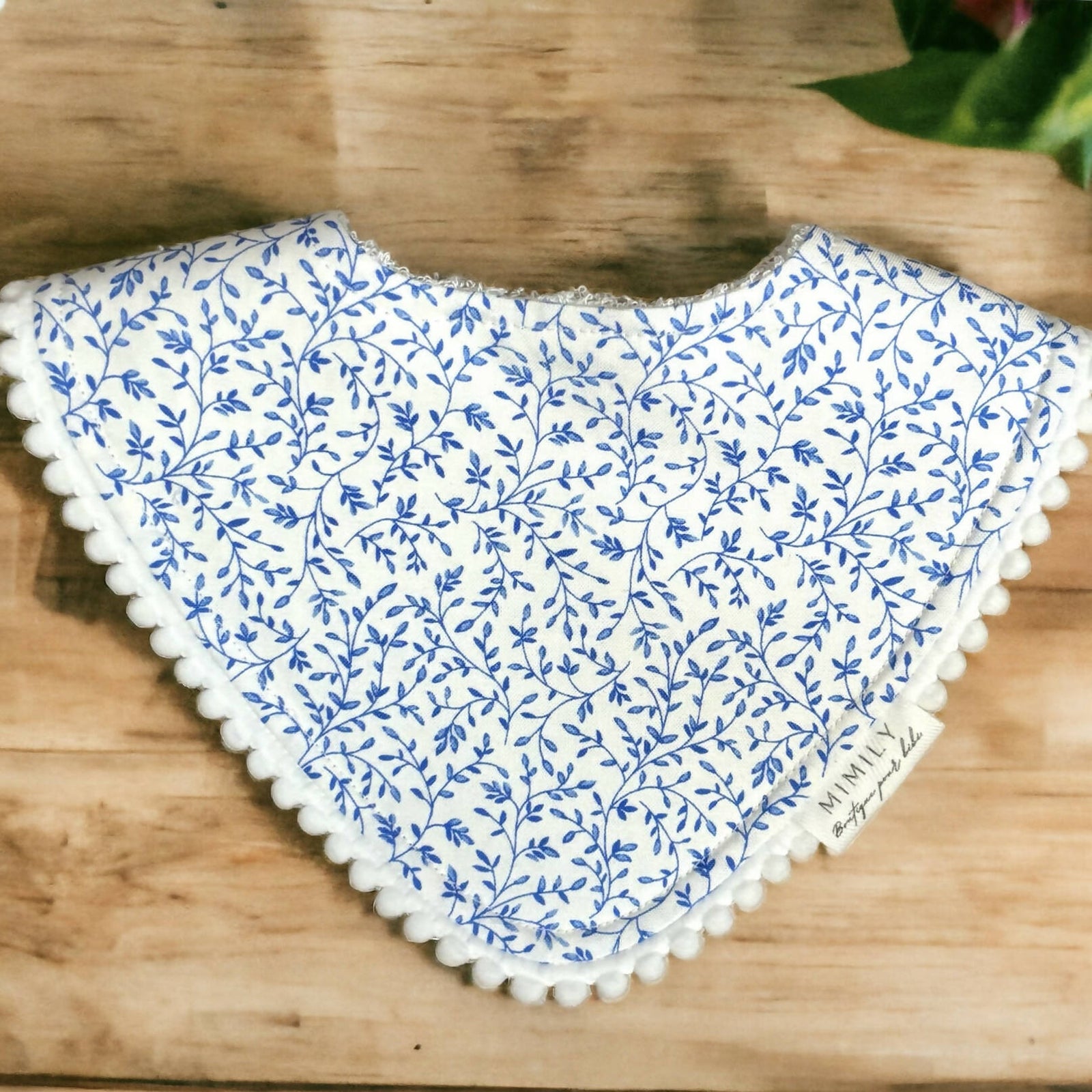 Mimily Boutique | Blue flower bib with pompoms